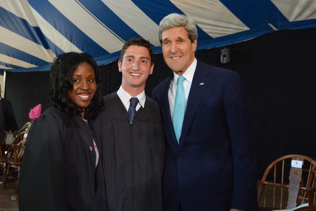 John Kerry, the class day speaker, poses with graduating students