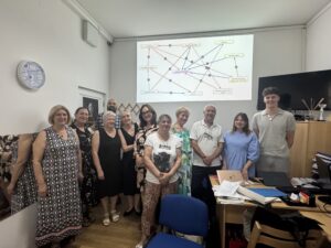A group of adults standing in front of a map