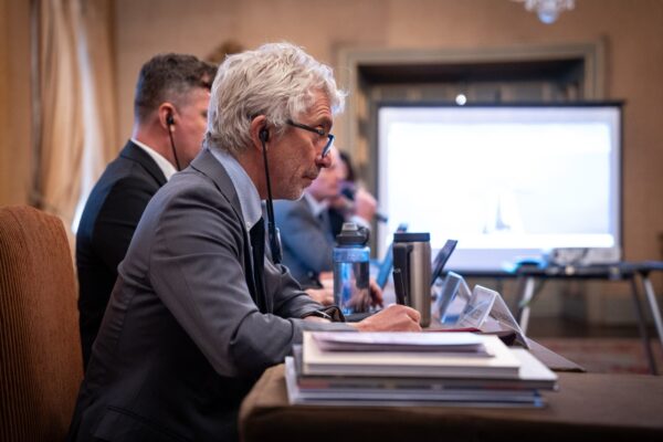 Graeme Reid on a UN panel, listening to a translation through an earphone